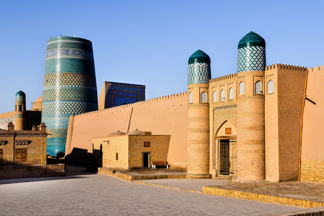 The historic skyline of Khiva's Itchan Kala with minarets and domes at golden hour