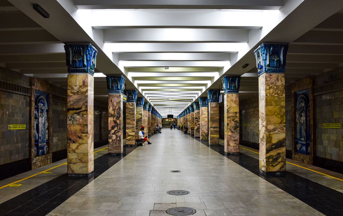 Decorative Tashkent metro station interior with elaborate ceiling design and chandeliers